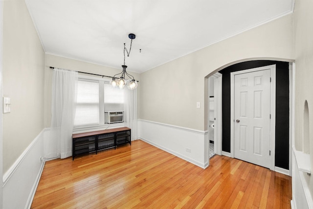 213 N Marion St Unit 1C, Oak Park, IL 60302 - unfurnished room with arched walkways, crown molding, light wood finished floors, a chandelier, and cooling unit