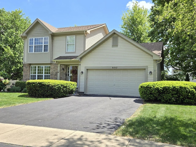 997 W Briarcliff Rd, Bolingbrook, IL 60440 - view of front of property with asphalt driveway, an attached garage, a front yard, and roof with shingles
