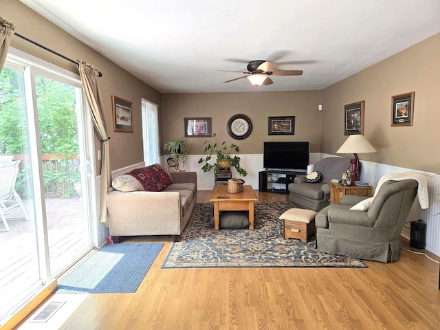 997 W Briarcliff Rd, Bolingbrook, IL 60440 - living area featuring wood finished floors, ceiling fan, and wainscoting