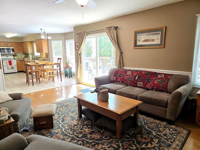997 W Briarcliff Rd, Bolingbrook, IL 60440 - living area featuring ceiling fan, light wood finished floors, and a chandelier