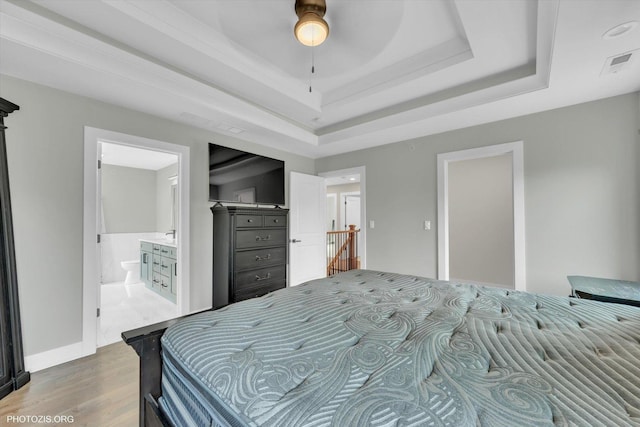 7218 S 78th Ave, Bridgeview, IL 60455 - bedroom featuring wood finished floors, a tray ceiling, and ensuite bathroom