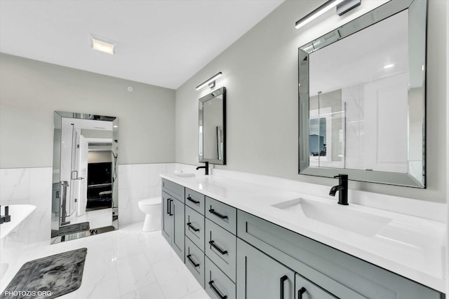 7218 S 78th Ave, Bridgeview, IL 60455 - full bath featuring double vanity, marble finish floors, a tub with marble appearance, toilet, and tile walls