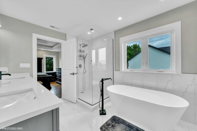 7218 S 78th Ave, Bridgeview, IL 60455 - ensuite bathroom with marble finish flooring, a shower stall, a soaking tub, double vanity, and recessed lighting