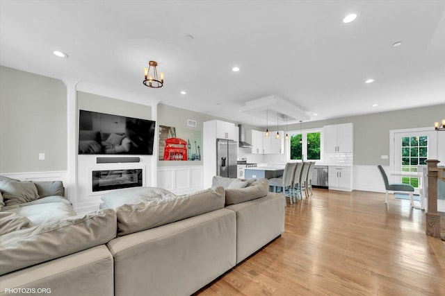 7218 S 78th Ave, Bridgeview, IL 60455 - living area featuring a chandelier, recessed lighting, light wood-style flooring, and wainscoting