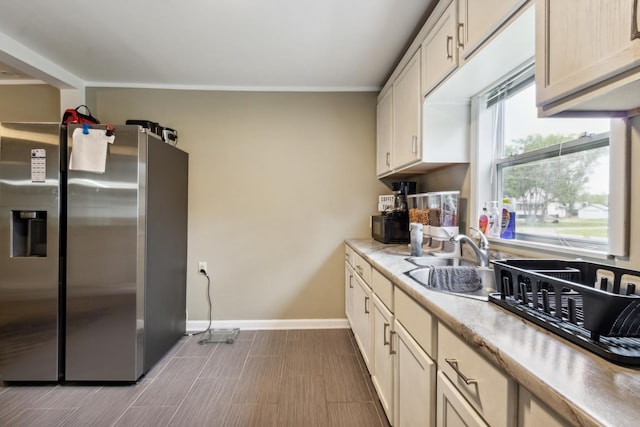 1818 W 9th St, Dixon, IL 61021 - kitchen with a sink, stainless steel fridge with ice dispenser, baseboards, and light countertops