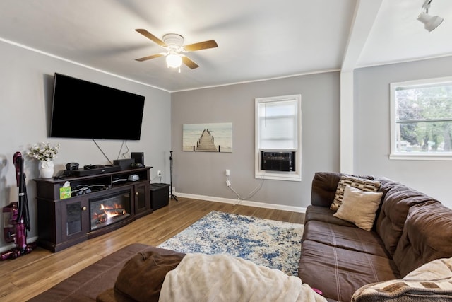 1818 W 9th St, Dixon, IL 61021 - living room featuring ceiling fan, wood finished floors, baseboards, cooling unit, and a glass covered fireplace