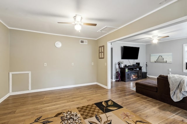 1818 W 9th St, Dixon, IL 61021 - living area with a ceiling fan, light wood-type flooring, baseboards, and crown molding