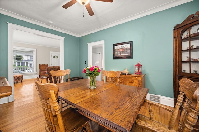 216 S Genoa St, Genoa, IL 60135 - dining space with ceiling fan, crown molding, and light wood-type flooring