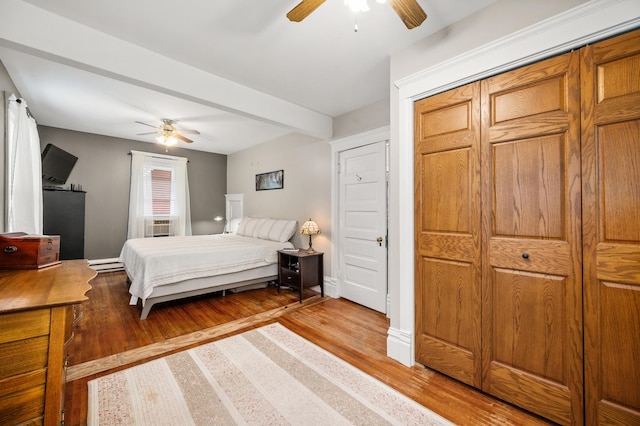 216 S Genoa St, Genoa, IL 60135 - bedroom with wood finished floors, beamed ceiling, a ceiling fan, and baseboards