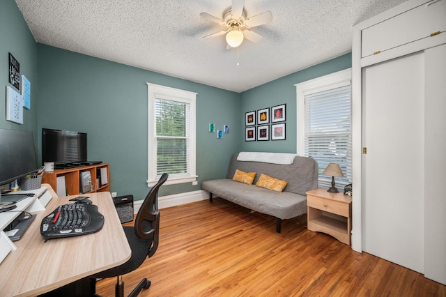 216 S Genoa St, Genoa, IL 60135 - office space featuring ceiling fan, wood finished floors, and a textured ceiling