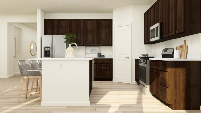 1111 Waterford St, Algonquin, IL 60102 - kitchen with appliances with stainless steel finishes, light wood finished floors, a center island, and dark brown cabinetry