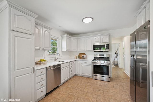 1208 N Dunton Ave, Arlington Heights, IL 60004 - kitchen featuring appliances with stainless steel finishes, a sink, light countertops, and white cabinets