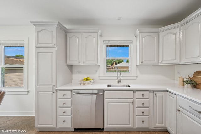 1208 N Dunton Ave, Arlington Heights, IL 60004 - kitchen featuring stainless steel dishwasher, a sink, light countertops, and white cabinetry