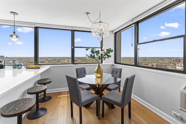 2700 N Hampden Ct Unit 24A, Chicago, IL 60614 - dining room with baseboards, a chandelier, and wood finished floors