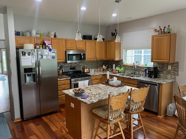 39510 N Cambridge Blvd, Beach Park, IL 60083 - kitchen featuring appliances with stainless steel finishes, a sink, dark wood-style floors, decorative backsplash, and a center island