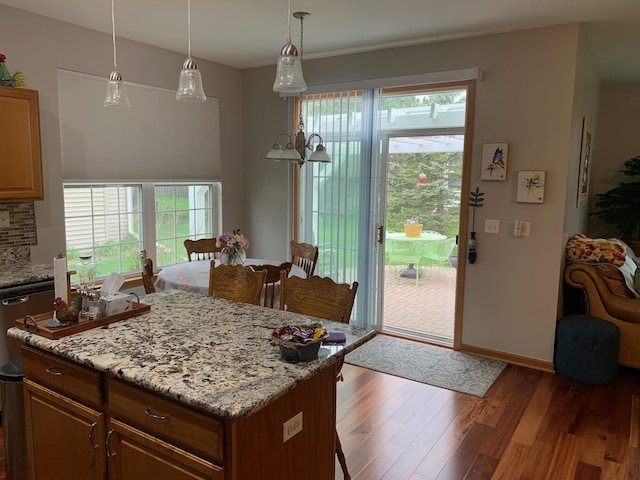 39510 N Cambridge Blvd, Beach Park, IL 60083 - kitchen featuring wood finished floors, a center island, light stone countertops, backsplash, and pendant lighting