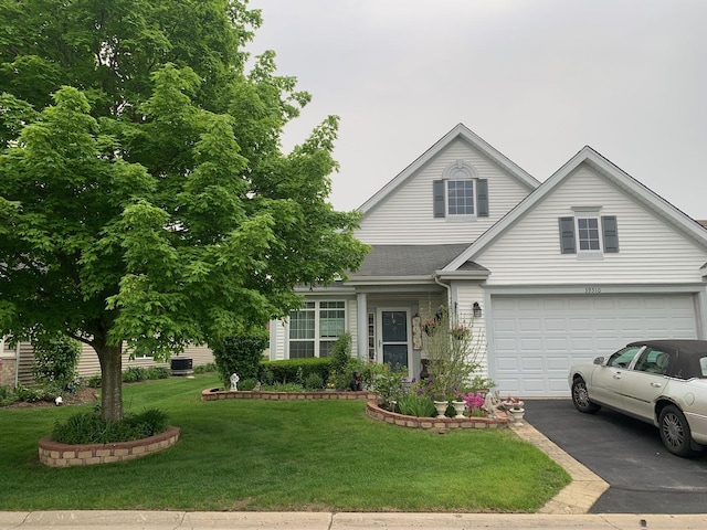 39510 N Cambridge Blvd, Beach Park, IL 60083 - traditional-style house with asphalt driveway, a front yard, and an attached garage