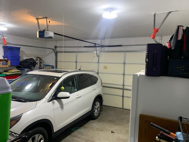 39510 N Cambridge Blvd, Beach Park, IL 60083 - garage featuring a garage door opener and freestanding refrigerator