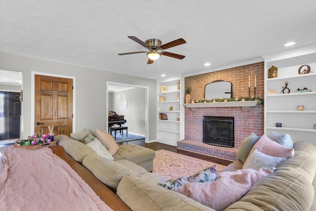 1517 Bridge Point Ln, Champaign, IL 61822 - living area with wood finished floors, baseboards, a ceiling fan, built in features, and a fireplace