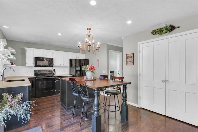 1517 Bridge Point Ln, Champaign, IL 61822 - kitchen featuring black appliances, a sink, open shelves, dark wood-style flooring, and a chandelier