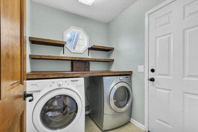 1517 Bridge Point Ln, Champaign, IL 61822 - laundry area with separate washer and dryer, light tile patterned floors, and baseboards