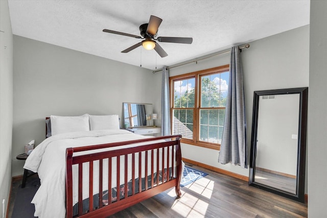 1517 Bridge Point Ln, Champaign, IL 61822 - bedroom with wood finished floors, baseboards, a textured ceiling, and a ceiling fan