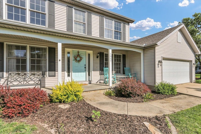 1517 Bridge Point Ln, Champaign, IL 61822 - traditional home featuring a porch, an attached garage, and concrete driveway