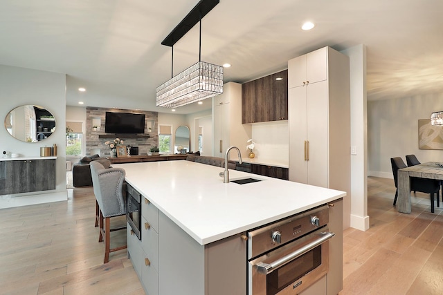 244 Kenmore Ave, Deerfield, IL 60015 - kitchen featuring a sink, light wood-style flooring, stainless steel oven, light countertops, and recessed lighting