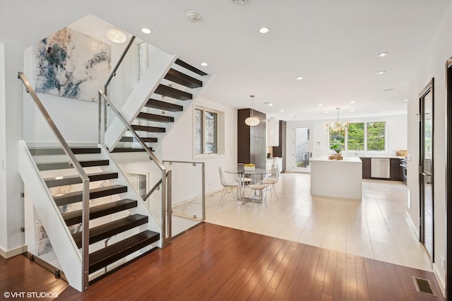 3635 N Paulina St, Chicago, IL 60613 - stairs with recessed lighting, wood finished floors, baseboards, and a chandelier