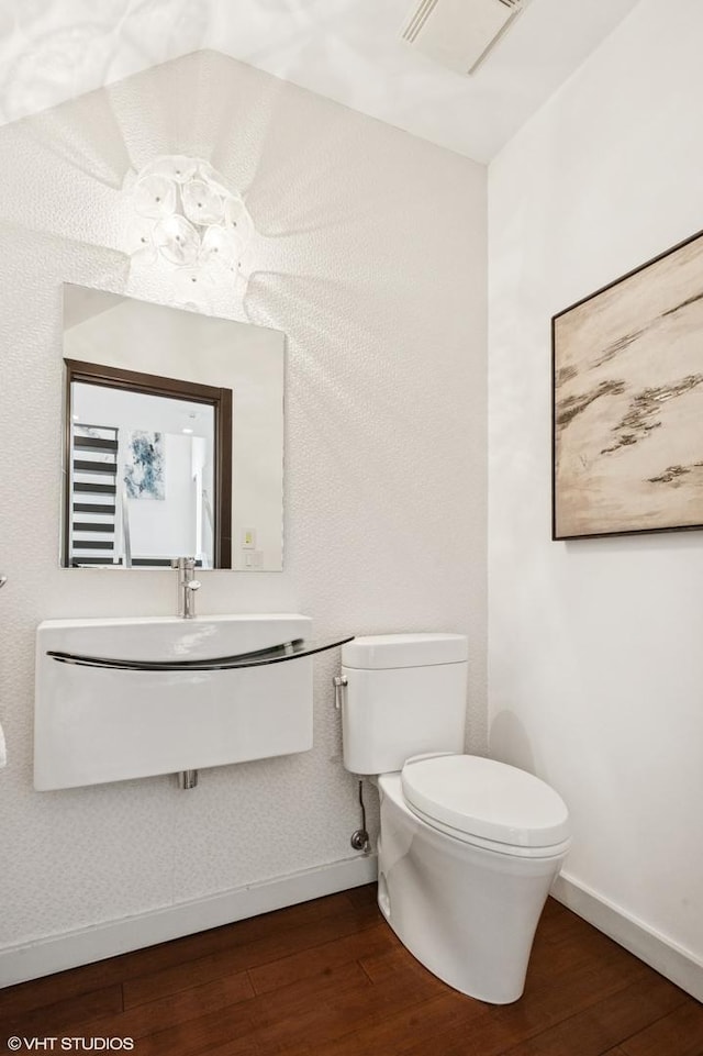 3635 N Paulina St, Chicago, IL 60613 - half bath featuring hardwood / wood-style flooring, baseboards, toilet, and vanity