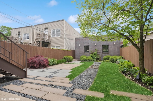 3635 N Paulina St, Chicago, IL 60613 - rear view of house with a fenced backyard, brick siding, and a patio