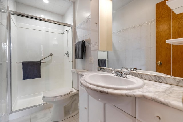 410 W Kirchhoff Rd, Arlington Heights, IL 60005 - bathroom with tile walls, vanity, a shower stall, toilet, and tile patterned floors
