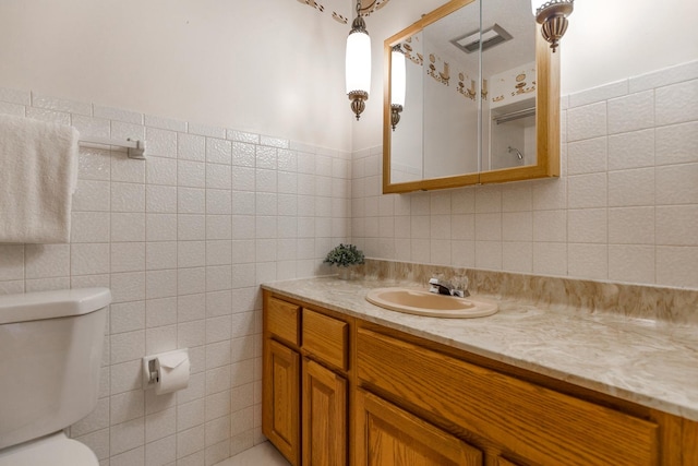 410 W Kirchhoff Rd, Arlington Heights, IL 60005 - bathroom with tile walls, toilet, and vanity