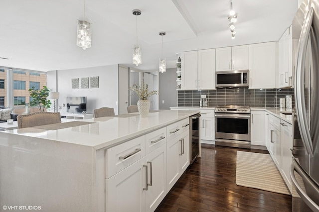 340 W Diversey Pkwy Unit 1020, Chicago, IL 60657 - kitchen with stainless steel appliances, backsplash, open floor plan, and dark wood-type flooring
