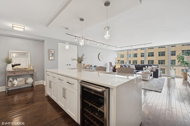 340 W Diversey Pkwy Unit 1020, Chicago, IL 60657 - kitchen featuring wine cooler, rail lighting, white cabinetry, dark wood-type flooring, and hanging light fixtures