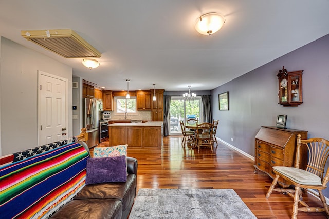 24W474 Surf Ct, Naperville, IL 60540 - living room featuring dark wood-style floors, a chandelier, and baseboards