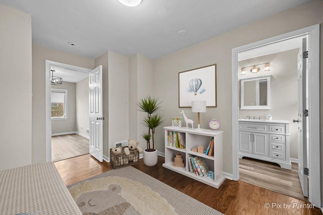 18371 Gladville Ave, Homewood, IL 60430 - hall with wood finished floors, baseboards, and a chandelier