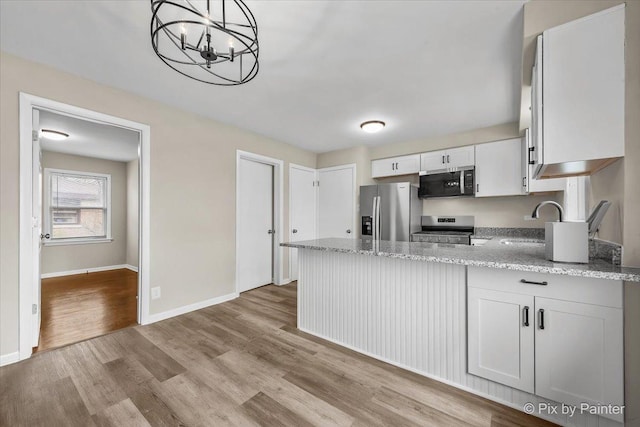 18371 Gladville Ave, Homewood, IL 60430 - kitchen featuring stainless steel appliances, a peninsula, a sink, light wood-type flooring, and light stone counters
