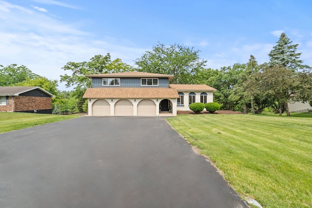 22308 S Eastcliff Dr, Joliet, IL 60404 - tri-level home featuring asphalt driveway, a front yard, roof with shingles, and a garage