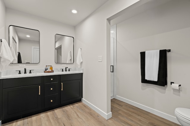 22308 S Eastcliff Dr, Joliet, IL 60404 - bathroom with wood finished floors, double vanity, a stall shower, and recessed lighting