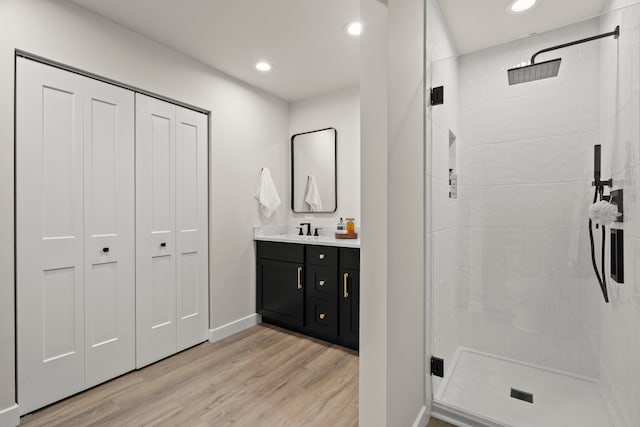 22308 S Eastcliff Dr, Joliet, IL 60404 - full bathroom with a tile shower, wood finished floors, a closet, vanity, and recessed lighting