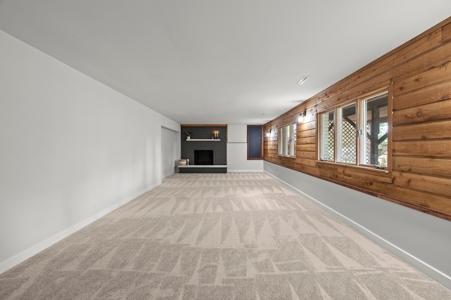 22308 S Eastcliff Dr, Joliet, IL 60404 - unfurnished living room with light colored carpet, a fireplace, and wooden walls