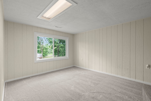 22308 S Eastcliff Dr, Joliet, IL 60404 - empty room featuring a textured ceiling, carpet flooring, and wooden walls