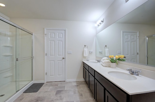 208 Cooper St, Plano, IL 60545 - bathroom featuring double vanity, a shower stall, and baseboards