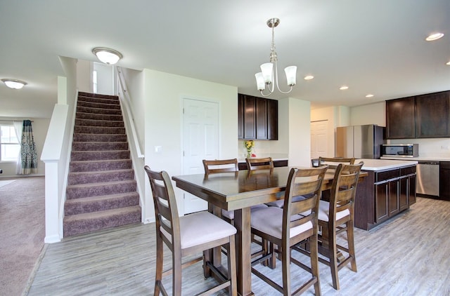 208 Cooper St, Plano, IL 60545 - dining area featuring light wood finished floors, stairway, a chandelier, baseboards, and recessed lighting