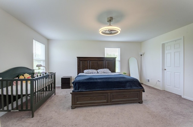 208 Cooper St, Plano, IL 60545 - bedroom featuring light colored carpet, multiple windows, and baseboards