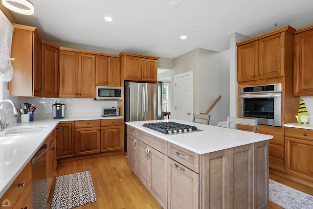 3404 Royal Woods Dr, Crystal Lake, IL 60014 - kitchen featuring stainless steel appliances, light wood finished floors, a kitchen island, light countertops, and recessed lighting