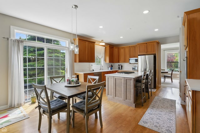 3404 Royal Woods Dr, Crystal Lake, IL 60014 - kitchen featuring stainless steel appliances, a center island, light wood-type flooring, light countertops, and recessed lighting