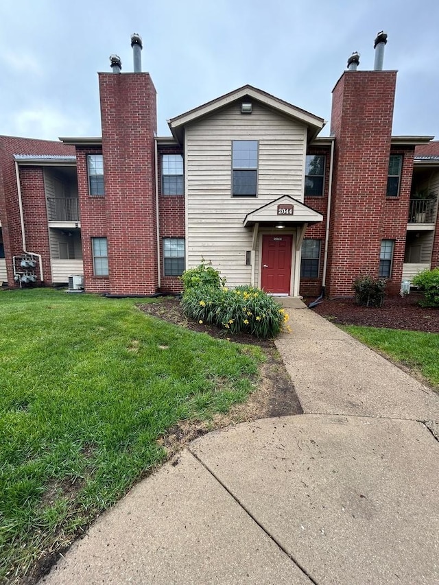 2044 N Rand Rd Unit 107, Palatine, IL 60074 - view of front facade with a front lawn and a chimney