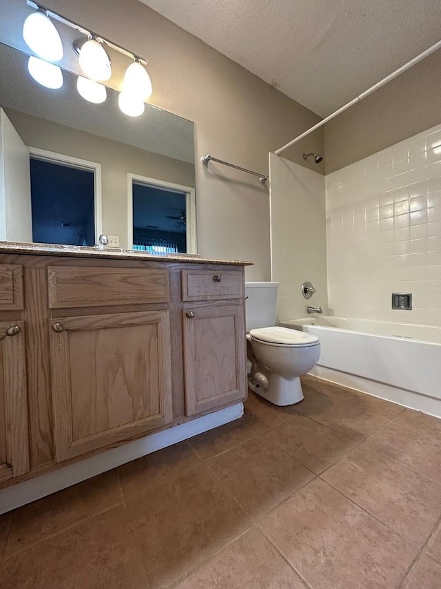2044 N Rand Rd Unit 107, Palatine, IL 60074 - full bathroom with tub / shower combination, vanity, toilet, tile patterned flooring, and a textured ceiling